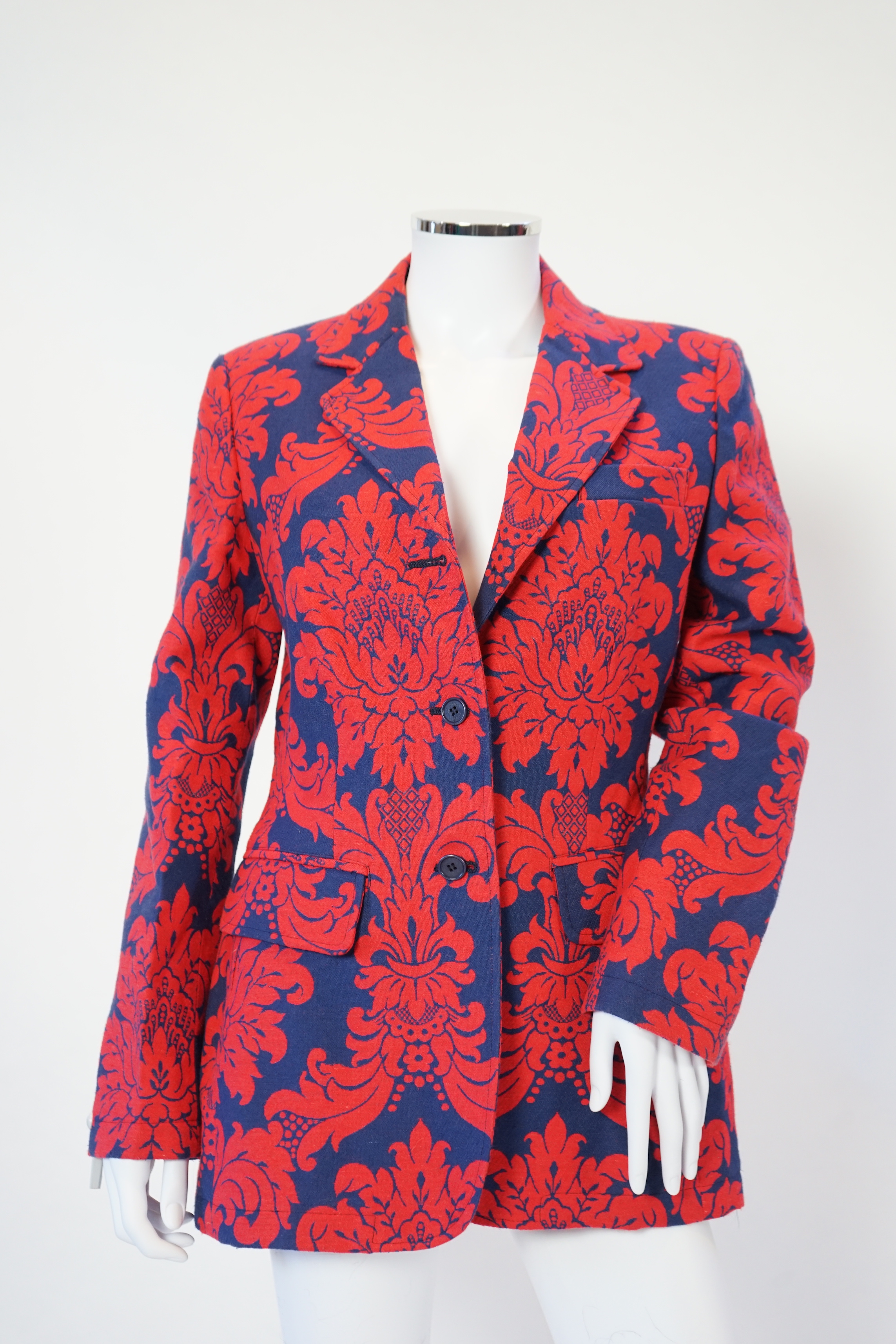 A Moschino lady's long blue and red jacket, a cream cotton embellished blazer and a cotton pair of floral trousers, blue and red jacket size 14, cream blazer size 12, trousers size: 10